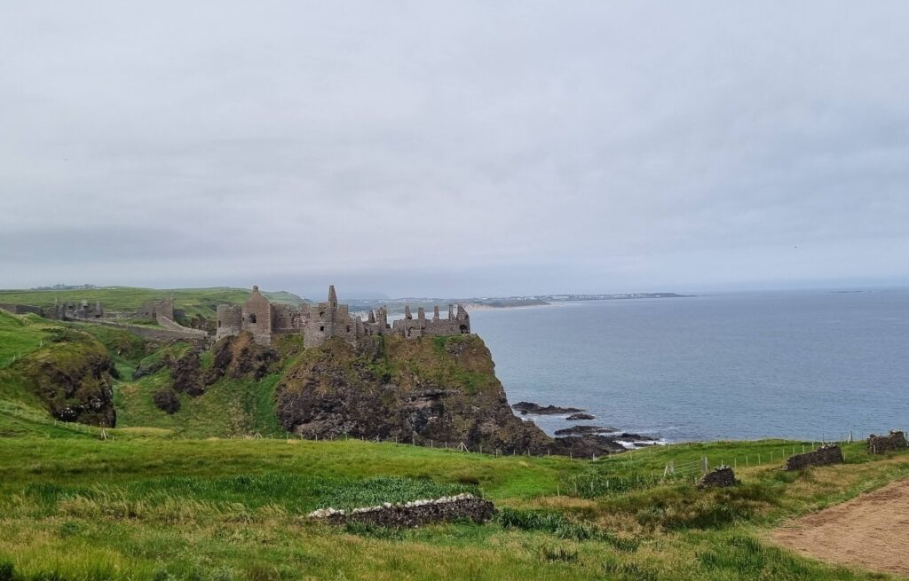 Em um penhasco, é possível ver as ruínas do Castelo de Dunluce, na Irlanda do Norte